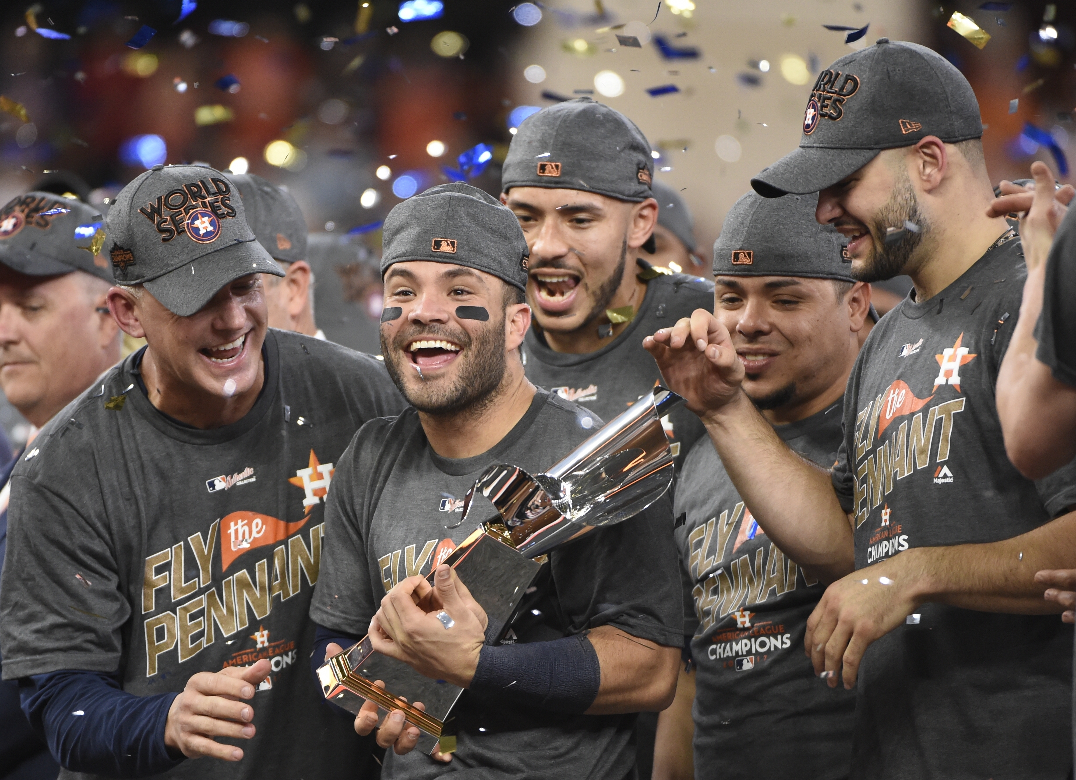 Houston Astros second baseman Jose Altuve holds the3 World Series  championship trophy during the Astros World Ser…