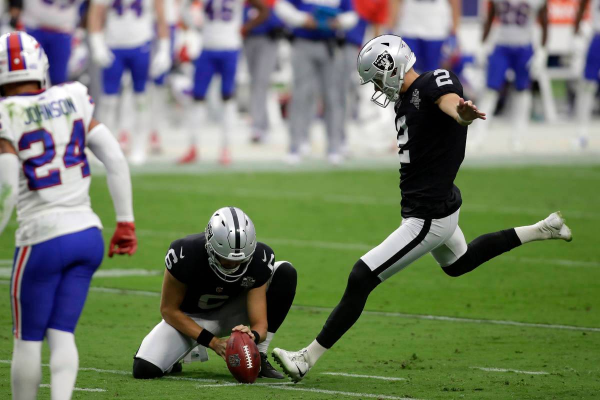 Raiders kicker Daniel Carlson (2) celebrates by eating a turkey